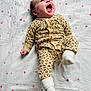 Maddy participe au concours pour gagner de l'argent avec cette photo : baby, blanket, child, cozy, cute, expression, face, happy, infant, joyful, leopard_print, lying_down, newborn, onesie, pink, smiling, socks, soft, stars, white