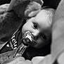 baby, pacifier, black_and_white, close_up, soft_toys, blurred_foreground, infant, face, eyes, child, cute, portrait, seat_belt, car_seat, monochrome, expression, soft_texture, young_child, clothing, indoors