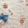 baby, infant, child, blanket, headband, white_top, blue_pants, white_shoes, star_pattern, wooden_ring, milestone, age_marker, lying_down, smile, portrait, indoors, cute, baby_photo, soft_lighting, head