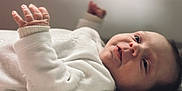 Maddy participe au concours pour gagner de l'argent avec cette photo : baby, child, closeup, curious, cute, expression, face, hand, indoors, infant, lying_down, natural_light, newborn, peaceful, portrait, skin, sleepwear, soft_surface, white_clothing, young
