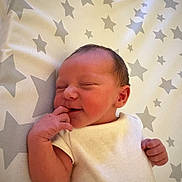 Sandy-Ann is registered to the contest to win money with this photo: newborn, baby, infant, sleeping, blanket, stars, pattern, hand, face, skin, cute, peaceful, white_clothing, lying_down, small, adorable, indoors, soft, portrait, child