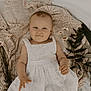 Gabriella is registered to the contest to win money with this photo: baby, bed, blanket, bonnet, clothing, cradle, crib, cushion, face, furniture, happy, hat, head, homedecor, infantbed, newborn, person, photography, portrait, smile