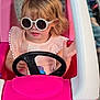 Gracelyn is registered to the contest to win money with this photo: accessory, blonde_hair, child, clothing, cute, fashion, fun, hands, indoors, person, pink, play, portrait, seat, steering_wheel, sunglasses, toddler, toy_car, vehicle, young_child