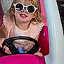 child, girl, sunglasses, toy_car, pink, smile, blonde_hair, steering_wheel, indoor, play, happy, cute, person, fashion, accessory, casual, fun, portrait, seat, hands