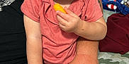 Gracelyn is registered to the contest to win money with this photo: baby, bodypart, clothing, couch, cushion, cutlery, face, finger, food, furniture, hand, head, homedecor, person, photography, portrait, shorts, sitting, spoon, t_shirt