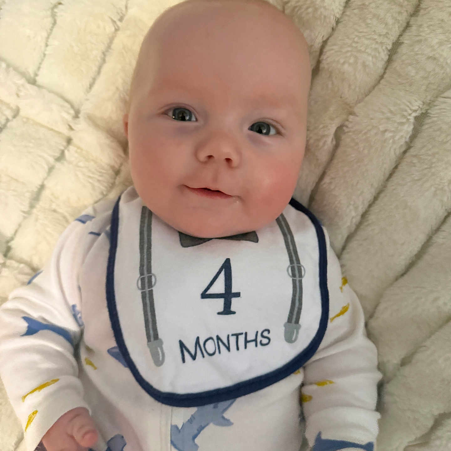 Kastle is registered to the contest to win money with this photo: baby, baby_girl_or_boy, bib, blanket, child, clothing, cute, eyes, face, hand, happy, head, infant, lying_down, newborn, pajamas, skin, smile, soft, young