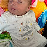 Evie joined the competition — help win amazing prizes! baby, newborn, sleeping, onesie, animal_print, rainbow, colorful_blanket, pig_face, soft_texture, infant, cute, peaceful, child, portrait, cozy, closeup, face, head, clothing, resting