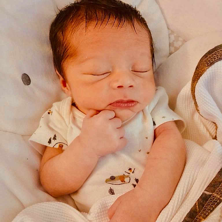 Zayden is registered to the contest to win money with this photo: baby, blanket, child, cozy, cute, face, hand, head, indoors, infant, newborn, onesie, peaceful, person, portrait, resting, skin, sleeping, soft, young