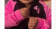 Tori Jones is registered to the contest to win money with this photo: beads, black_clothing, braided_hair, child, closeup, clothing, curious_expression, cute, face, girl, hands, human, indoor, jacket, person, pink_clothing, portrait, standing, toddler, young