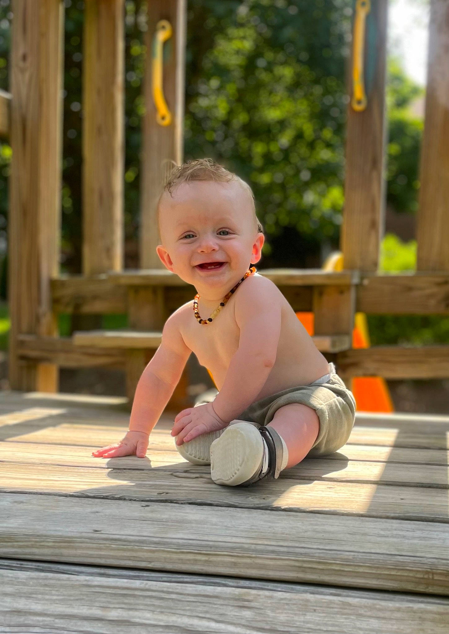 Brodie is registered to the contest to win money with this photo: baby, baby_toddler_clothing, barefoot, child, eye, flooring, foot, fun, grass, happy, hardwood, head, joy, leaf, leisure, people_in_nature, person, sitting, smile, standing