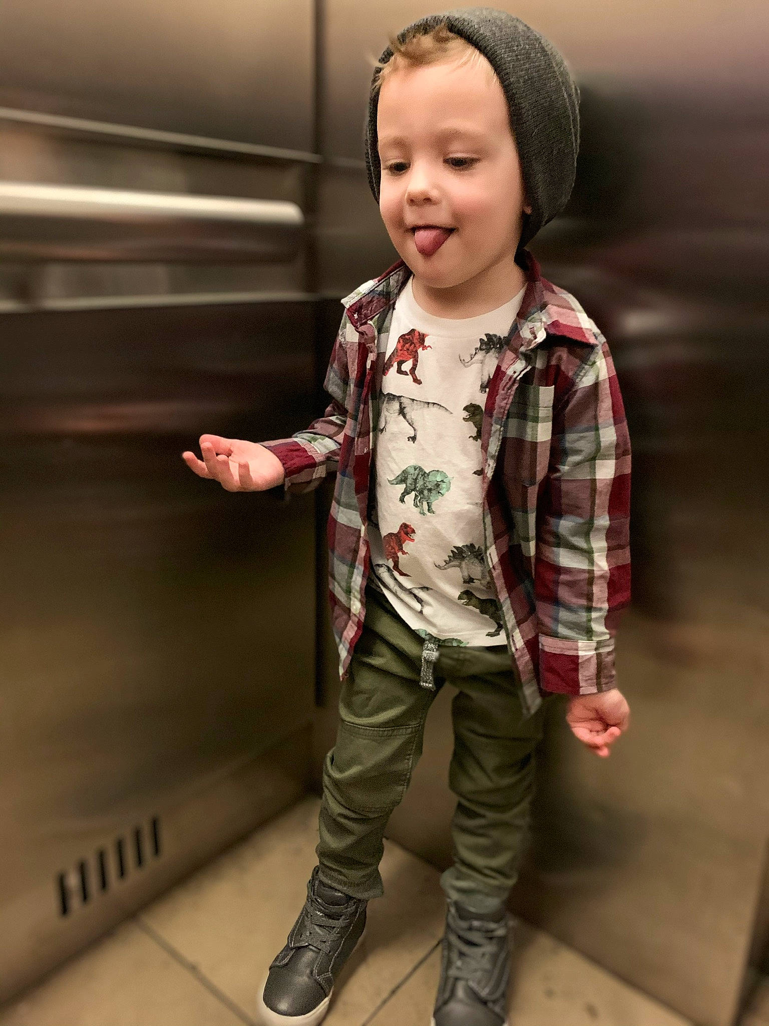 Derek is registered to the contest to win money with this photo: cheek, child, child_model, cool, design, face, footwear, head, jacket, jeans, joy, nose, outerwear, pattern, person, plaid, sleeve, smile, standing, t_shirt