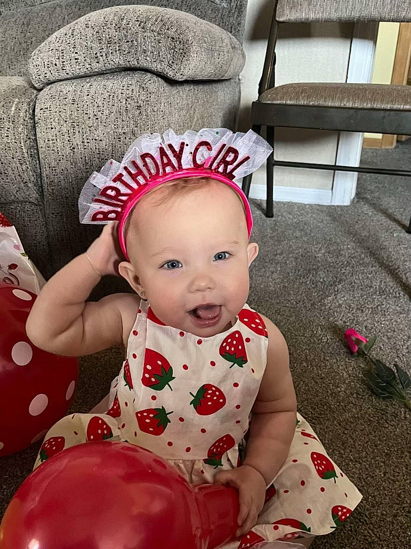 Ashtyn joined the competition — help win amazing prizes! baby, baby_toddler_clothing, carmine, cheek, child, comfort, costume_hat, dress, face, flooring, happy, pattern, person, pink, red, sitting, skin, sleeve, textile, toddler