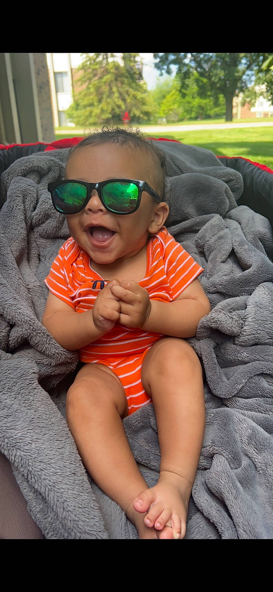 Franklin is registered to the contest to win money with this photo: arm, cool, eye, eyewear, glasses, goggles, grass, happy, human_body, leg, leisure, mouth, person, plant, shoulder, skin, smile, sunglasses, thigh, toddler