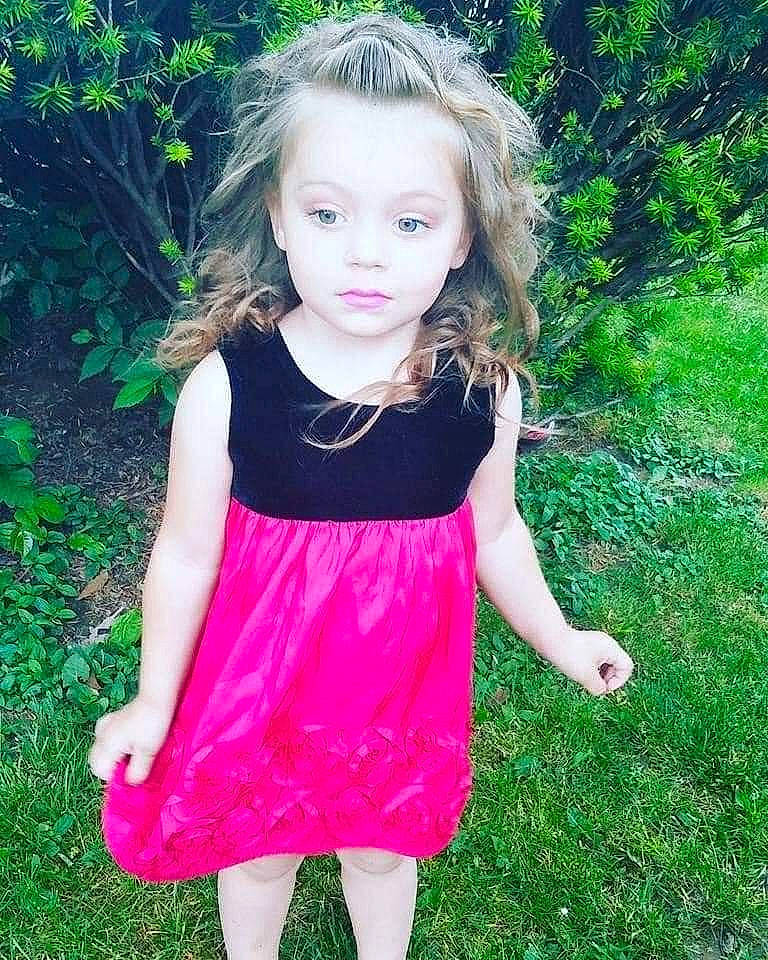 Merella is registered to the contest to win money with this photo: baby_toddler_clothing, day_dress, dress, eye, face, grass, hair, happy, head, human_body, magenta, one_piece_garment, people_in_nature, person, pink, plant, shoulder, skin, sleeve, summer