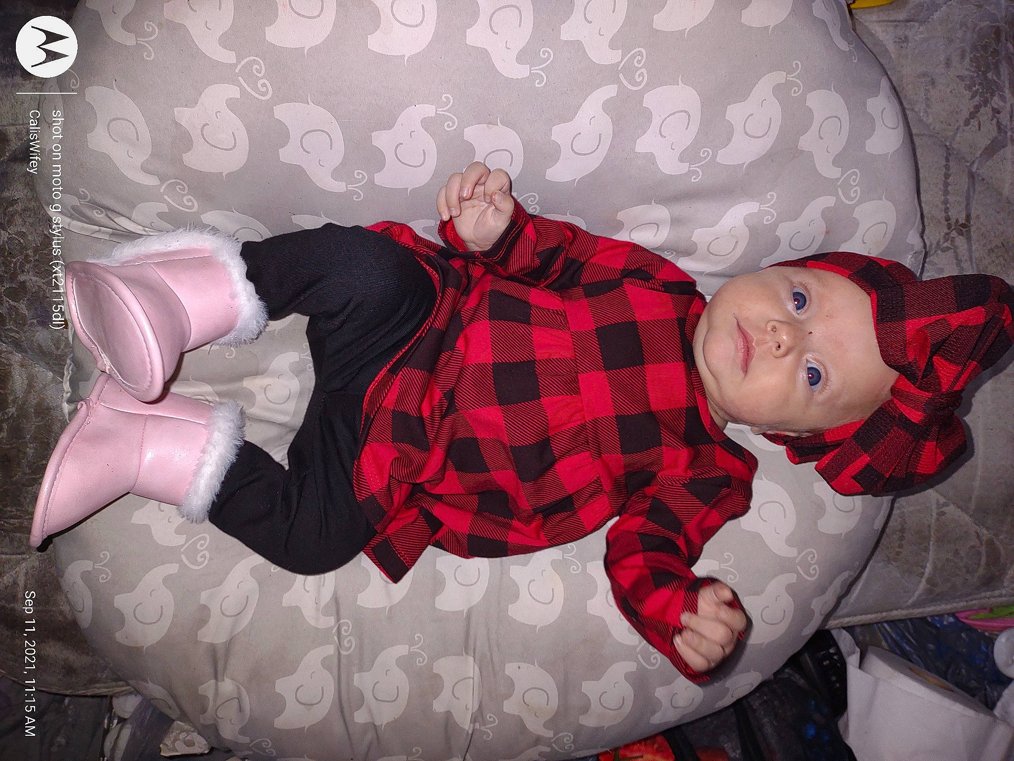 Olivia is registered to the contest to win money with this photo: baby_toddler_clothing, carmine, christmas, christmas_eve, comfort, couch, event, headwear, lap, leg, linens, pattern, person, plaid, room, sitting, sock, tartan, textile, thigh