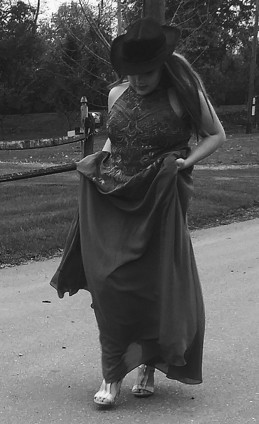 Cynthia joined the competition — help win amazing prizes! asphalt, black, black_and_white, eyewear, fedora, gesture, grey, hat, headgear, monochrome, monochrome_photography, person, plant, road_surface, shoulder, standing, street_fashion, style, sun_hat, tree