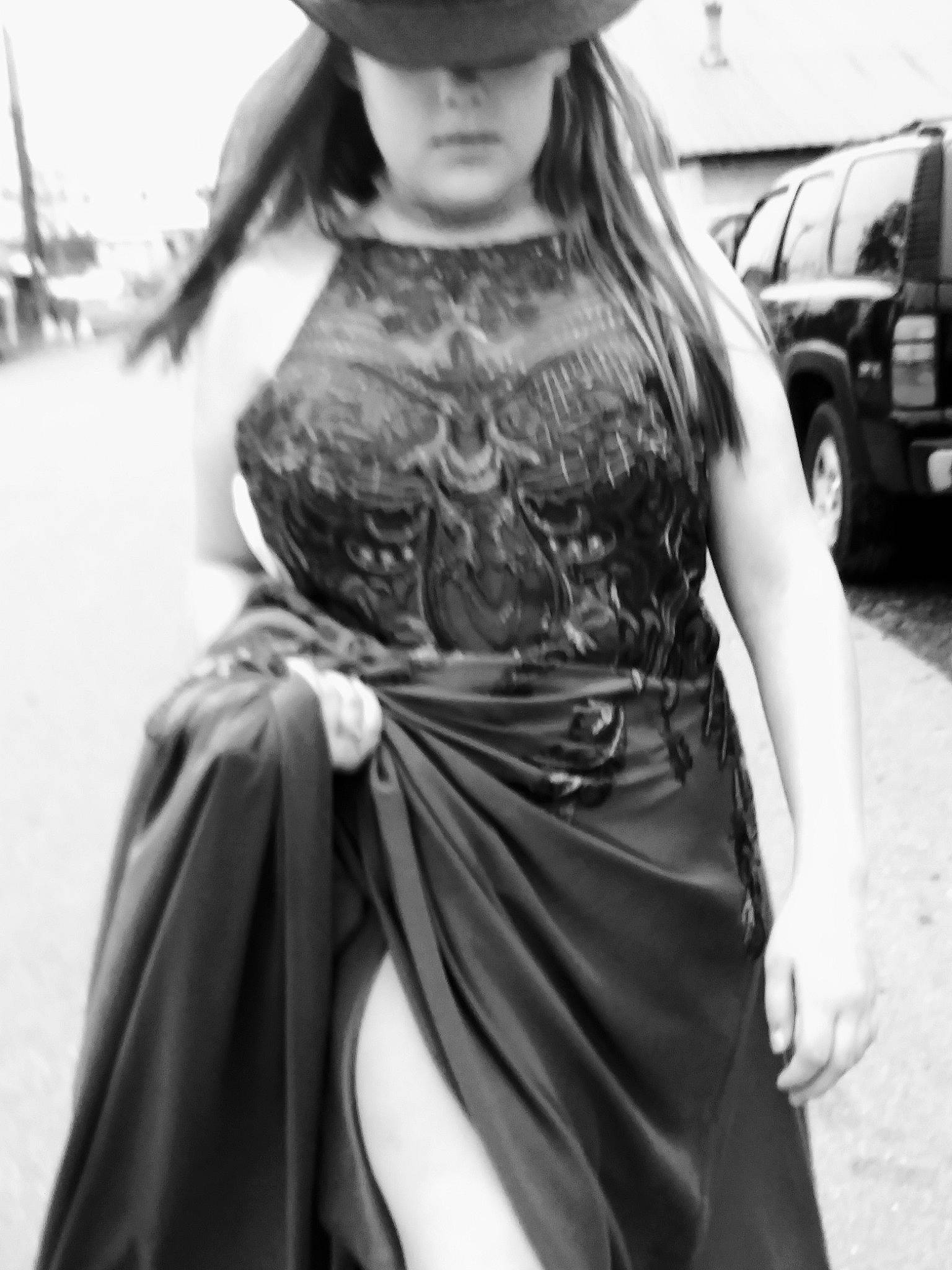 Cynthia is registered to the contest to win money with this photo: black, black_and_white, black_hair, day_dress, dress, fashion_design, formal_wear, gown, hat, long_hair, monochrome, monochrome_photography, motor_vehicle, person, shoulder, standing, street_fashion, style, tire, waist
