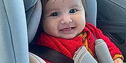 Aëlya participe au concours pour gagner de l'argent avec cette photo : baby, baby_toddler, car_interior, car_seat, child, clothing, face, happy, head_support, indoors, knitted_clothing, portrait, red_sweater, reflection, seat, seatbelt, smile, vehicle, window, young_child