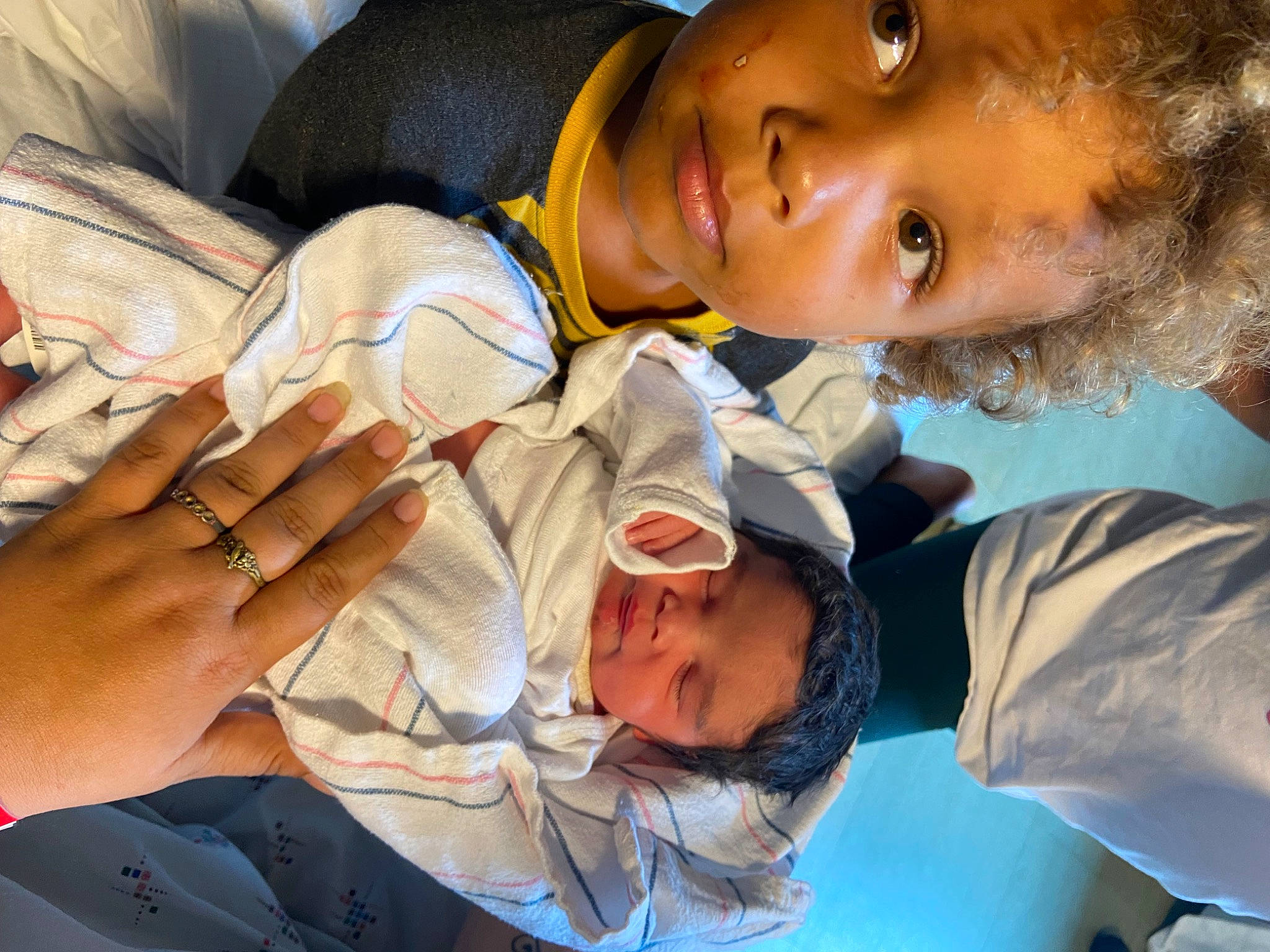 Jakobe is registered to the contest to win money with this photo: adaptation, arm, baby, child, comfort, community, event, finger, fun, gesture, hand, happy, hat, headwear, interaction, leisure, mouth, organ, person, sitting