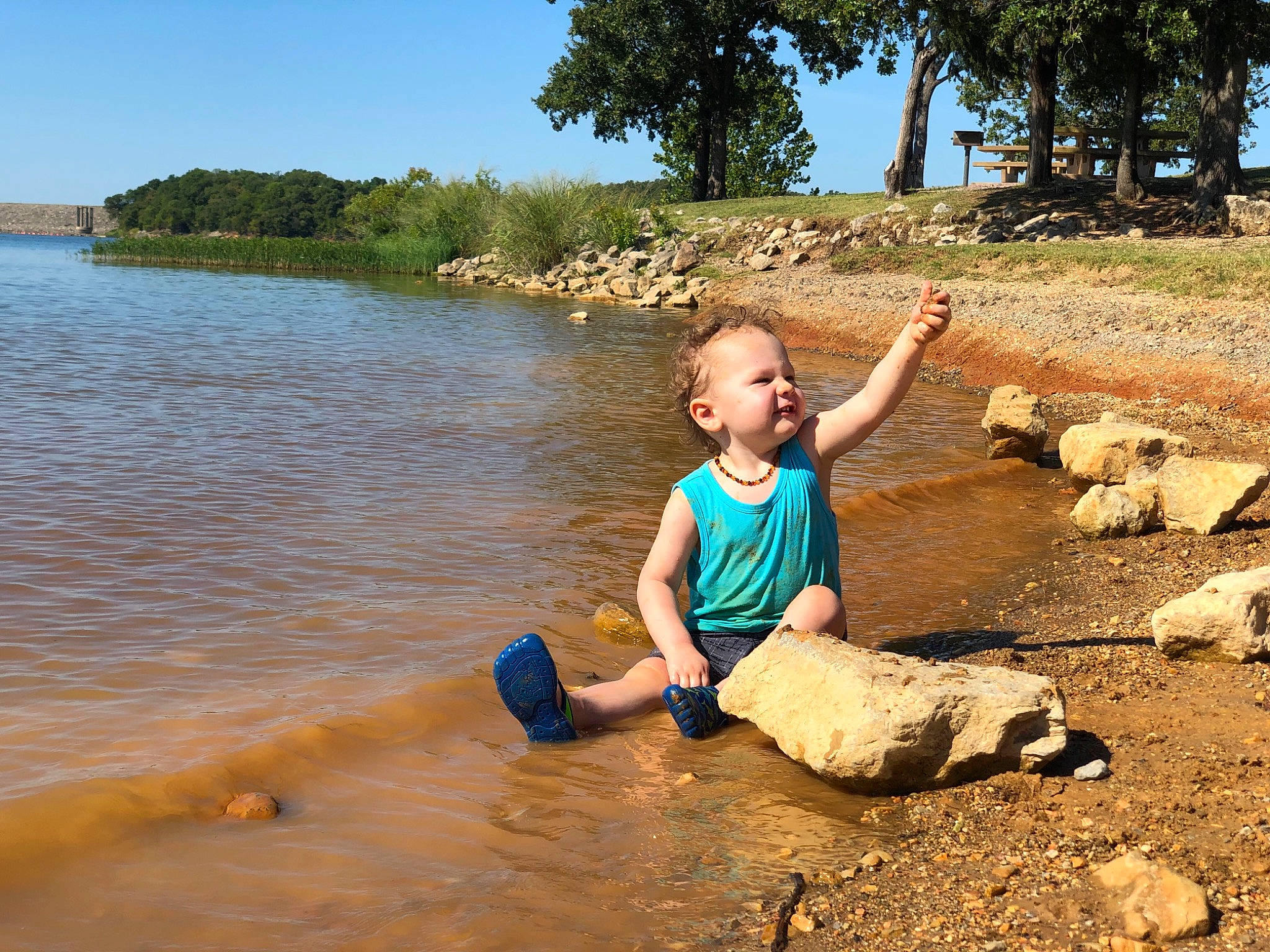 Teegan is registered to the contest to win money with this photo: bank, fawn, fun, leisure, person, rock, summer, vacation, water