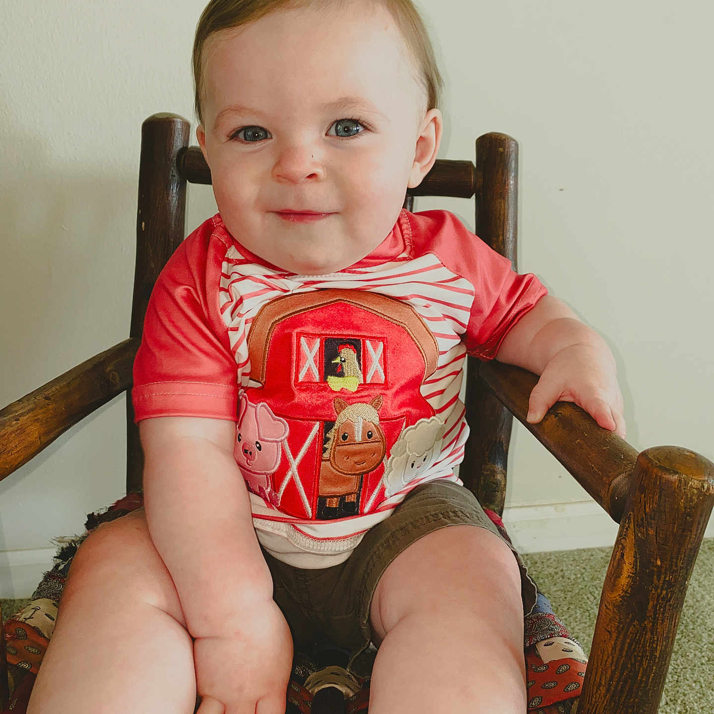Bennett is registered to the contest to win money with this photo: armchair, baby, bag, baseball, baseballglove, bodypart, chair, clothing, face, finger, furniture, glove, hand, head, person, photography, portrait, sitting, sport, t_shirt