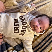 Jameson joined the competition — help win amazing prizes! baby, infant, hoodie, clothing, blanket, face, person, cute, child, smile, indoors, soft_texture, warm, cozy, small_hands, lying_down, happy, casual, portrait, sleepwear