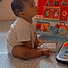 baby, child, toy, bottle, indoor, floor, playtime, curious, seated, pattern, blanket, colorful, plastic, early_childhood, person, infant, cute, looking_up, toddler, home