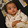 Akeilah joined the competition — help win amazing prizes! baby, child, infant, curly_hair, bow, blanket, clothing, cute, face, hand, indoors, person, portrait, seat, soft_toy, warm, expression, looking_away, sitting, cozy