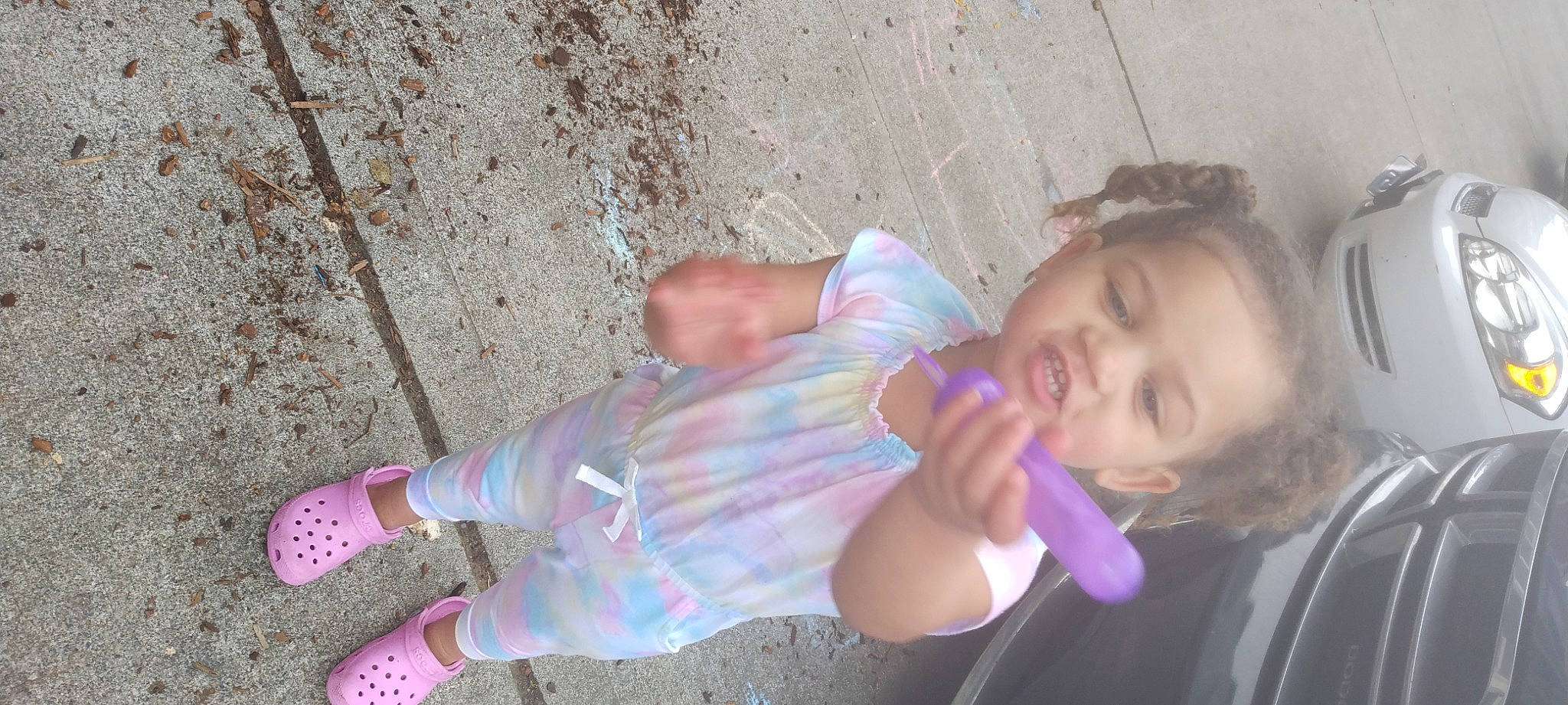 Kya'Rae is registered to the contest to win money with this photo: baby_toddler_clothing, child, clothing, cool, foot, fun, grass, happy, human_leg, leisure, nose, pattern, person, pink, sitting, skin, smile, sock, toddler, tree