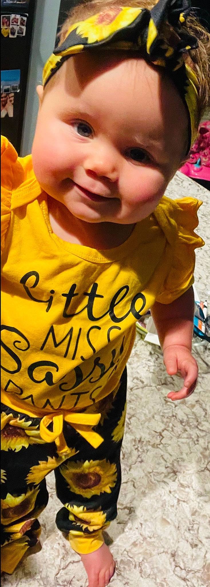 Lauryn is registered to the contest to win money with this photo: baby_laughing, baby_toddler_clothing, cheek, chin, cool, facial_expression, grass, hairstyle, happy, mouth, nose, organ, people, person, photograph, skin, sleeve, smile, t_shirt, toddler