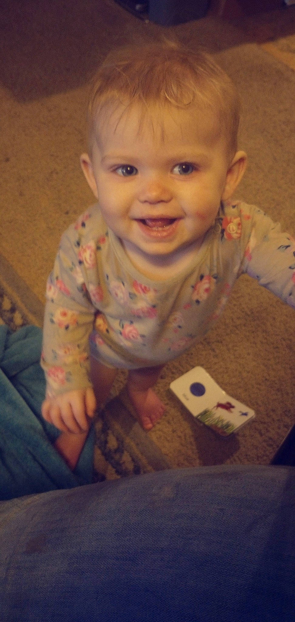 Addilynn is registered to the contest to win money with this photo: baby, baby_toddler_clothing, beauty, cheek, child, comfort, electronic_device, facial_expression, finger, flooring, fun, happy, joy, mouth, nose, person, sitting, skin, sleeve, smile