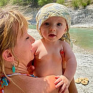 Liam a rejoint le concours — aidez-le/la à gagner de superbes lots ! baby, child, earring, family, hair, hand, headscarf, holding, nature, outdoor, portrait, river, rock, sandals, skin, summer, sunlight, trees, water, woman
