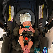Carson is registered to the contest to win money with this photo: baby, newborn, car_seat, pacifier, hat, sleeping, infant, child, seatbelt, safety, snugride_lite, protectplus, foot, hand, clothing, indoor, cute, rest, person, transportation