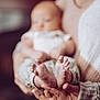 baby, feet, hands, holding, blurred_face, soft_focus, knitted_sweater, warm_colors, cozy, indoor, person, newborn, infant, skin, close_up, parent, comfort, care, small_toes, gentle