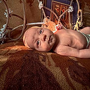 Axle joined the competition — help win amazing prizes! baby, infant, child, portrait, face, eyes, lying_down, blanket, indoor, home, rope, hammock, furniture, framed_picture, warm_lighting, sunlight, diaper, looking_at_camera, cozy, photography