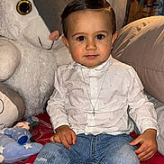 Keyden a rejoint le concours — aidez-le/la à gagner de superbes lots ! child, toddler, boy, indoor, plush_toy, bed, pillow, jeans, shirt, necklace, cross, socks, toy, curtains, smiling, sitting, comfortable, cute, portrait, home