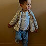 toddler, child, boy, jeans, jacket, shirt, sneakers, smile, pose, standing, indoor, wood_floor, beige_wall, casual_clothing, happy, person, cute, portrait, young_child, playful