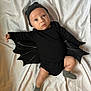 baby, infant, costume, bat_wings, black_clothing, hat, lying_down, white_background, cute, adorable, child, portrait, sock, one_person, indoors, fabric, expression, looking_up, small_child, soft_lighting