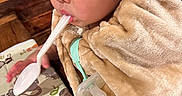 Nathan joined the competition — help win amazing prizes! toddler, child, baby, portrait, face, eyes, hair, blanket, bundled_up, straw, spoon, pacifier, activity_book, illustrations, wooden_background, indoor, cozy, sitting, close_up, adorable