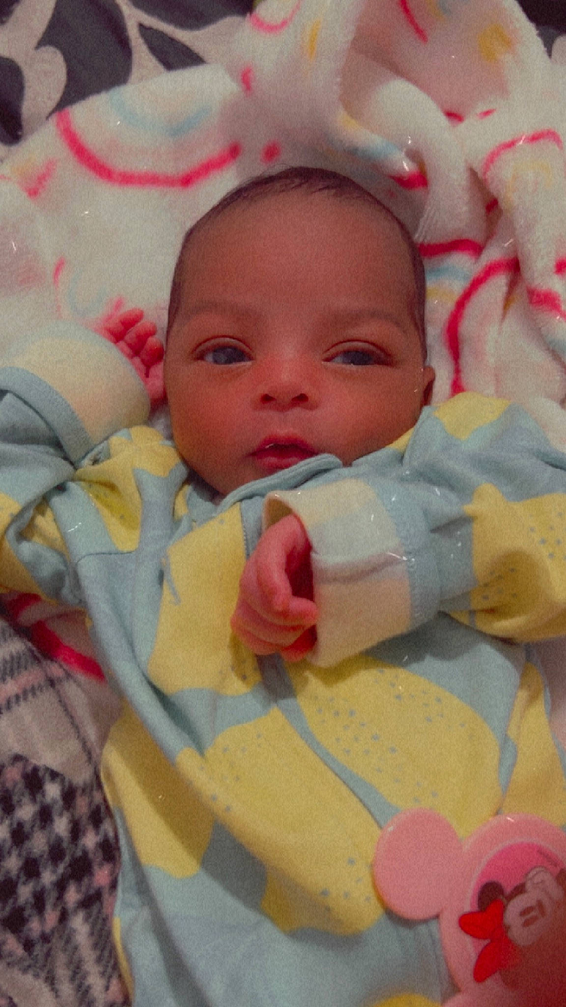 Sanai is registered to the contest to win money with this photo: baby, baby_products, baby_toddler_clothing, bib, cheek, child, comfort, happy, linens, lip, nose, pattern, person, pink, product, room, skin, smile, tartan, textile