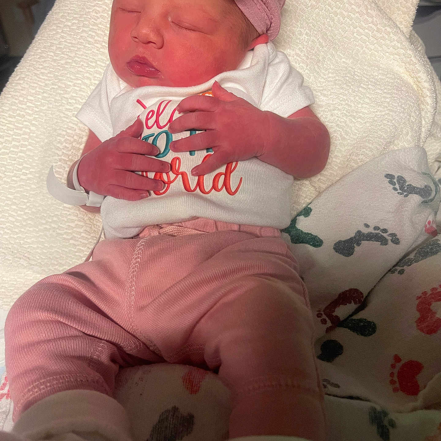Brenley joined the competition — help win amazing prizes! baby, blanket, closeup, clothing, cute, flower, footprints, hands, headband, indoors, infant, newborn, person, pink_pants, portrait, resting, sleeping, soft_texture, toddler, white_shirt