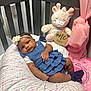 baby, infant, crib, pillow, plush_toy, giraffe, dress, headband, sock, girl, nursery, pink, blue, soft_toy, sleepy, child, cute, pattern, fabric, indoor