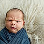 baby, baby_boy, blue_blanket, closeup, cozy, cute, expression, face, furrowed_brow, head, indoors, infant, newborn, person, portrait, skin, sleeping_area, soft_texture, white_background, wrapped