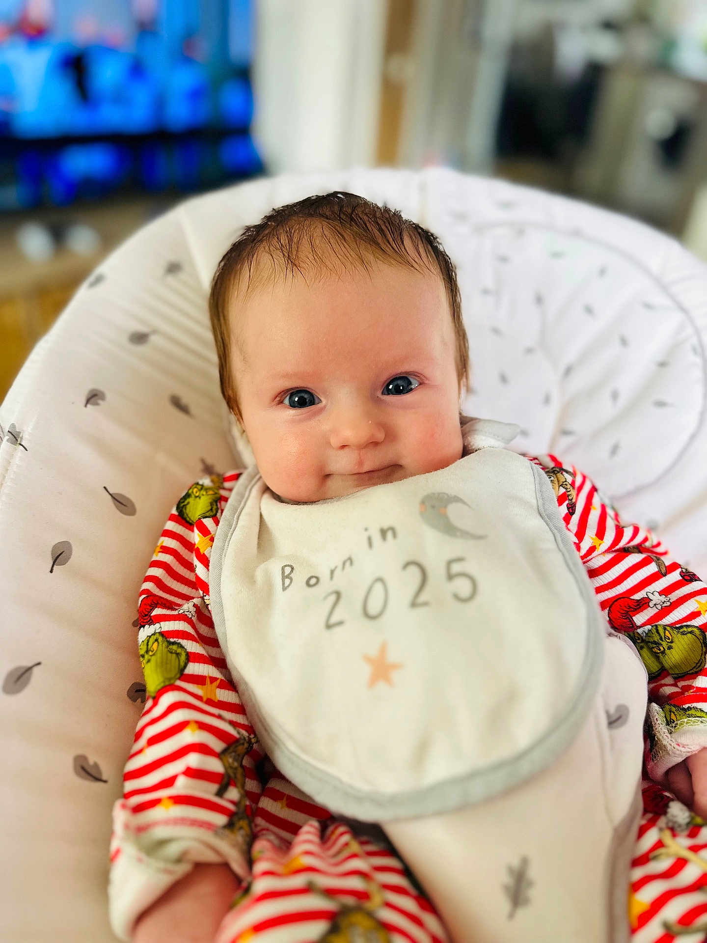 Athena joined the competition — help win amazing prizes! baby, infant, bib, red_striped_clothing, cushioned_seat, smile, face, eyes, hair, indoor, cute, child, newborn, apparel, fabric, pattern, person, portrait, soft_toy_pattern, comfort