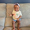 toddler, child, smiling, indoor, couch, denim_shorts, headband, minnie_mouse, shirt, barefoot, happy, person, furniture, living_room, cute, young_child, sitting, skin, clothing, portrait