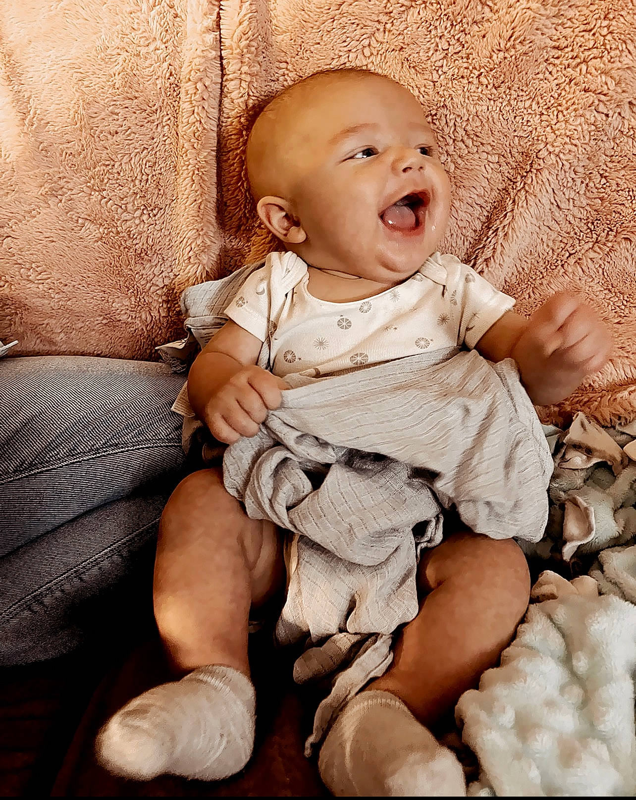 Kooper is registered to the contest to win money with this photo: arm, baby, baby_toddler_clothing, cheek, child, clothing, comfort, eye, finger, flash_photography, happy, human_leg, iris, pattern, person, sitting, skin, sleeve, smile, thigh