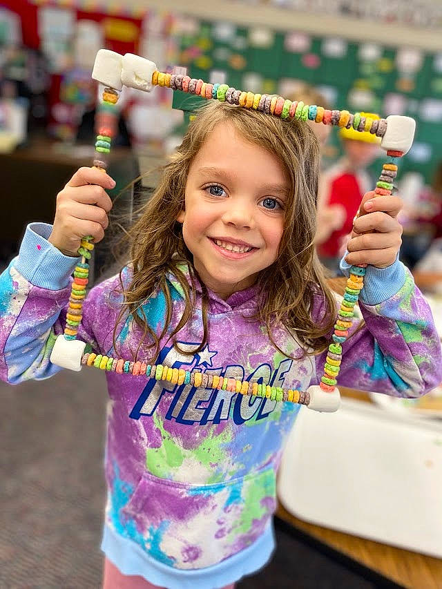 Larkin is registered to the contest to win money with this photo: arm, community, facial_expression, finger, fun, hair, hairstyle, hand, happy, human, joy, leisure, person, photograph, pink, product, public_space, recreation, sleeve, smile