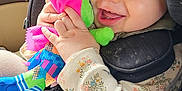 Scarlett joined the competition — help win amazing prizes! baby, child, car_seat, smiling, plush_toy, colorful, happy, infant, clothing, tights, seatbelt, indoor, car, window, portrait, cute, hands, face, light, fun