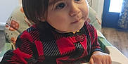 Ever joined the competition — help win amazing prizes! toddler, child, high_chair, red_sweater, black_sweater, checkered_pattern, indoor, kitchen, curious, face, person, long_hair, hand, table, furniture, baby, seat, expression, young_child, portrait