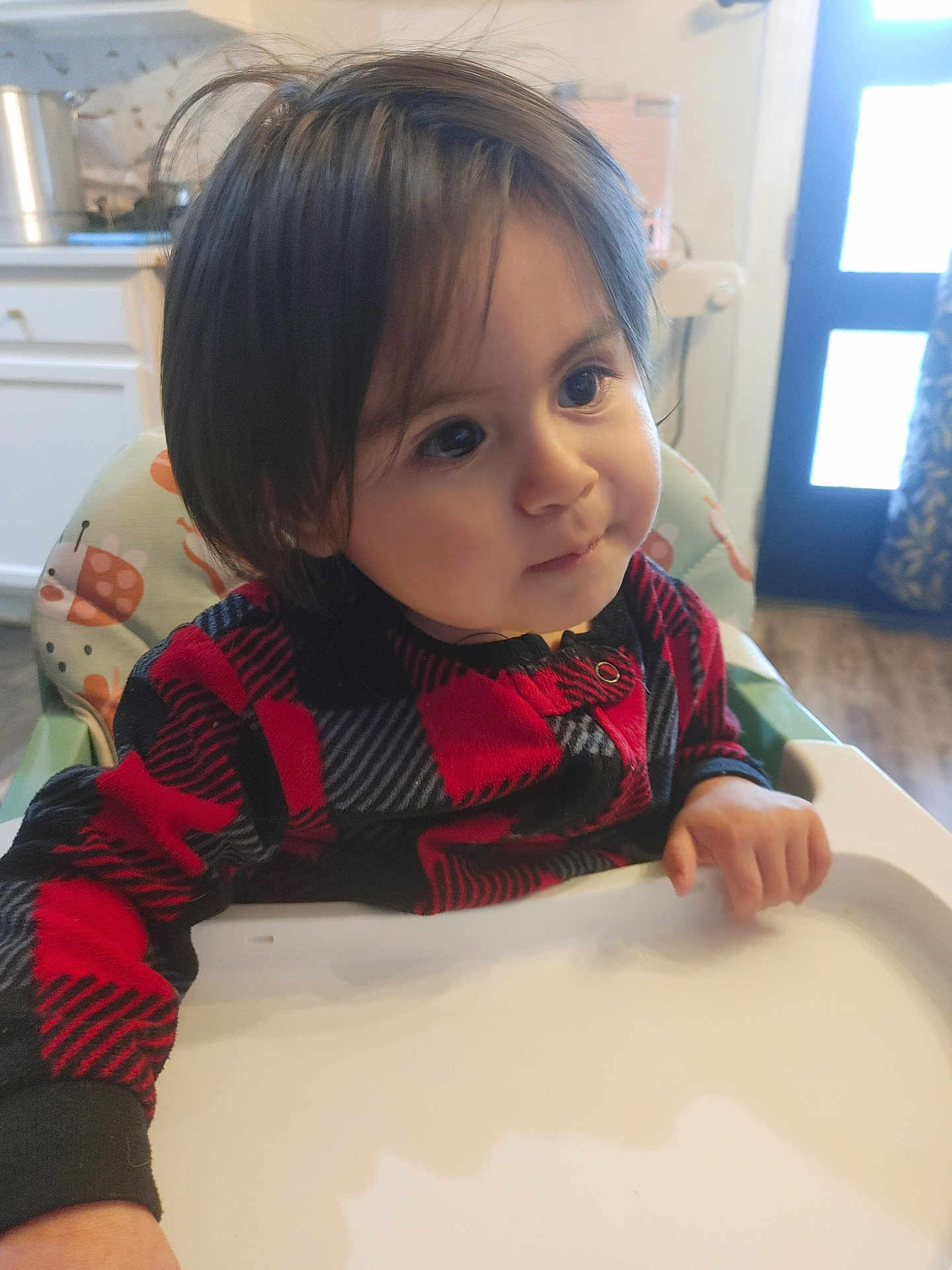 Ever joined the competition — help win amazing prizes! toddler, child, high_chair, red_sweater, black_sweater, checkered_pattern, indoor, kitchen, curious, face, person, long_hair, hand, table, furniture, baby, seat, expression, young_child, portrait